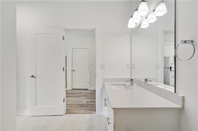 bathroom with hardwood / wood-style floors and vanity