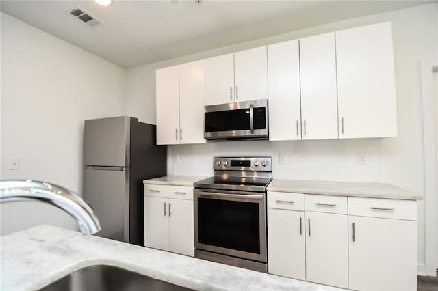 kitchen featuring white cabinetry, sink, and stainless steel appliances