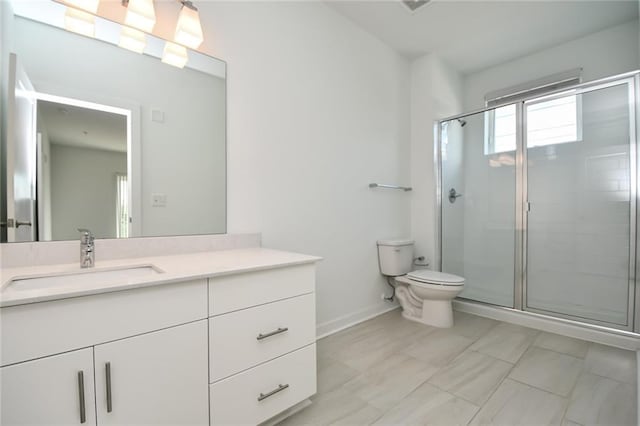 bathroom with an enclosed shower, vanity, and toilet