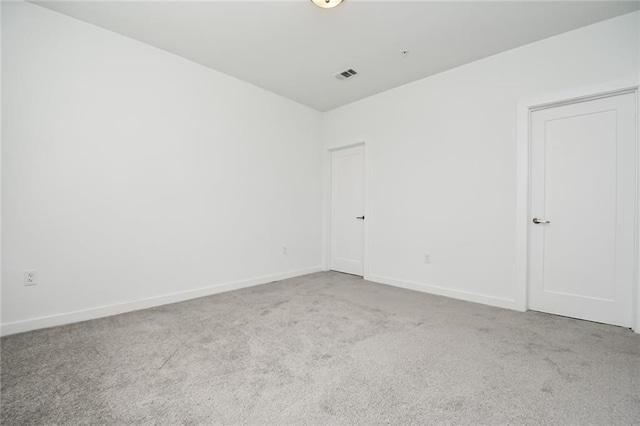 unfurnished room with light colored carpet