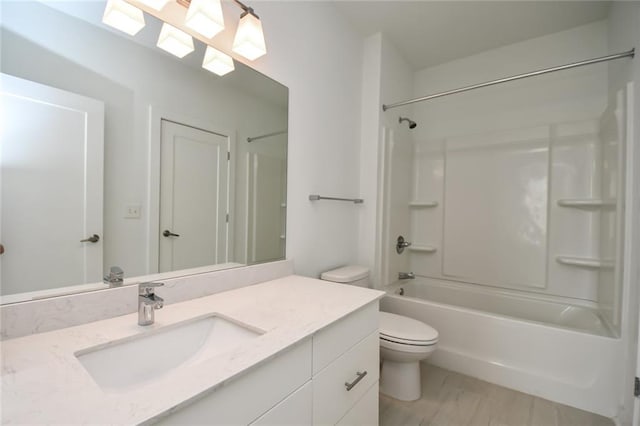 full bathroom featuring shower / washtub combination, vanity, and toilet