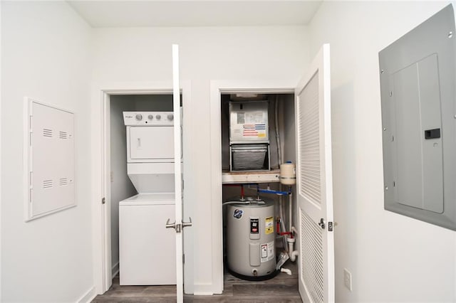 clothes washing area featuring electric water heater, dark hardwood / wood-style floors, stacked washer and clothes dryer, and electric panel