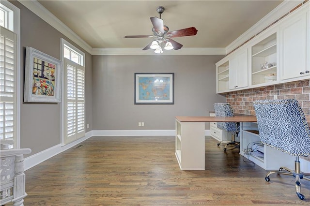 office area with visible vents, baseboards, a ceiling fan, wood finished floors, and crown molding