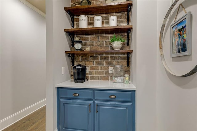 bar with tasteful backsplash, baseboards, and wood finished floors