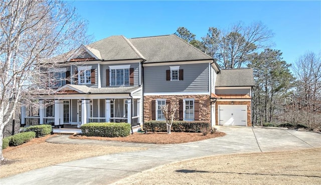 view of front of house featuring an attached garage, covered porch, concrete driveway, and roof with shingles