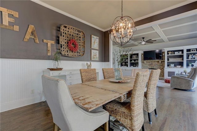 dining area featuring wood finished floors, a stone fireplace, wainscoting, and coffered ceiling