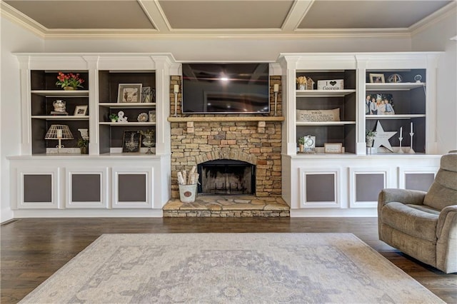 living room featuring ornamental molding, coffered ceiling, a stone fireplace, and wood finished floors