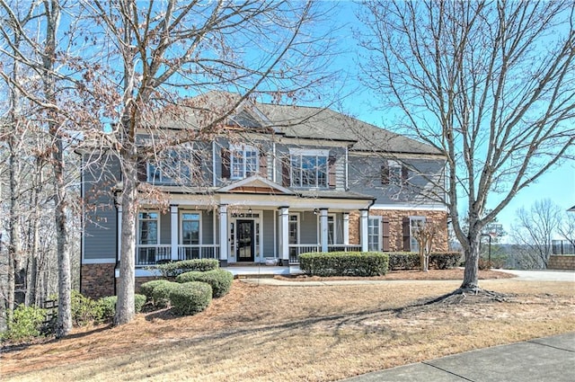 view of front facade featuring stone siding and a porch