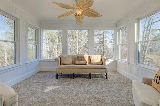 sunroom featuring a ceiling fan and a healthy amount of sunlight