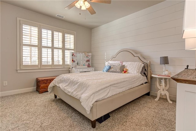 bedroom featuring light carpet, a ceiling fan, visible vents, and baseboards