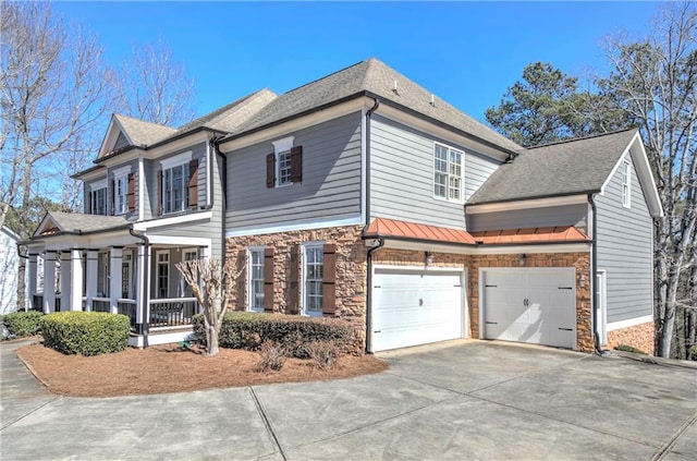 view of side of home with a shingled roof, concrete driveway, an attached garage, a sunroom, and stone siding