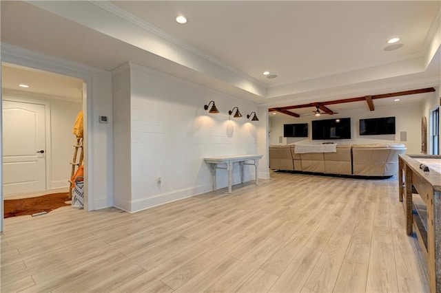 living area featuring light wood finished floors, recessed lighting, a raised ceiling, and crown molding