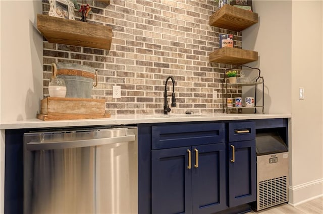 bar with brick wall, a sink, baseboards, stainless steel dishwasher, and light wood finished floors