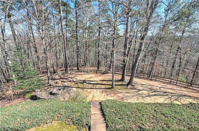 view of yard featuring fence and a view of trees