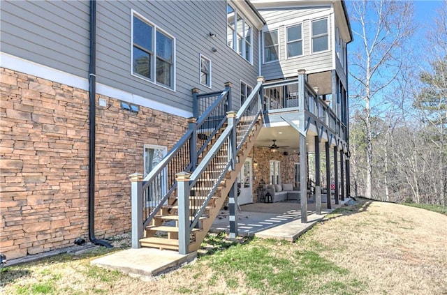 back of property featuring ceiling fan, a patio, and stairs