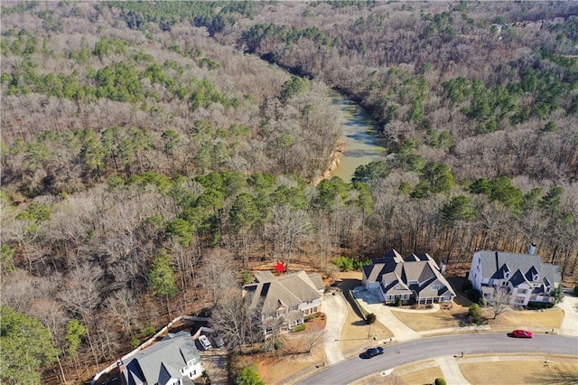 birds eye view of property featuring a wooded view