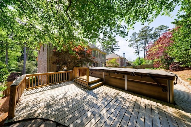wooden terrace with a hot tub