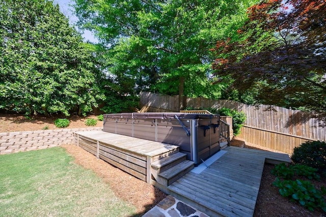 wooden terrace with fence and a hot tub