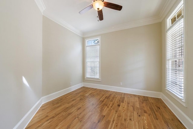 empty room with a ceiling fan, baseboards, crown molding, and light wood finished floors
