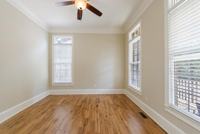 unfurnished room with light wood-type flooring, a ceiling fan, visible vents, and crown molding
