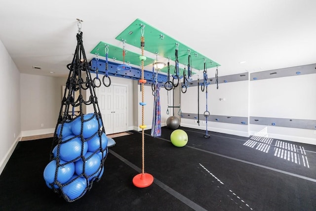 exercise room featuring baseboards and visible vents