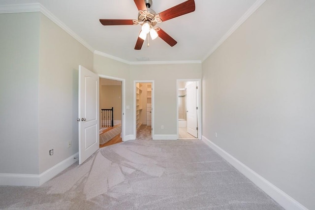 unfurnished bedroom with carpet, baseboards, ornamental molding, and connected bathroom