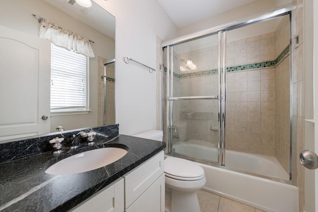 bathroom with shower / bath combination with glass door, tile patterned floors, visible vents, toilet, and vanity