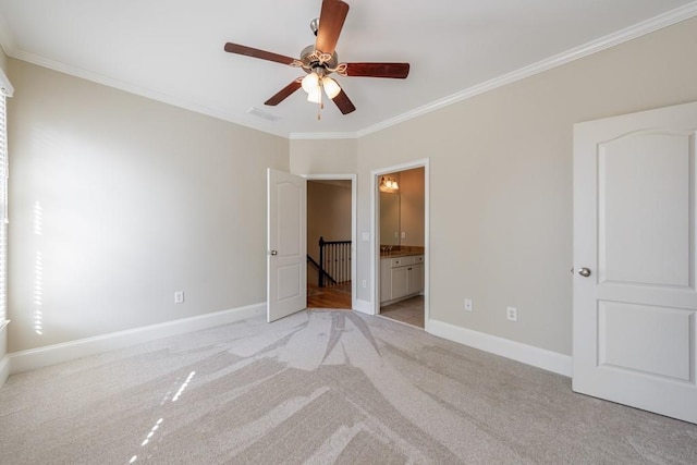 unfurnished bedroom featuring visible vents, light carpet, baseboards, and crown molding