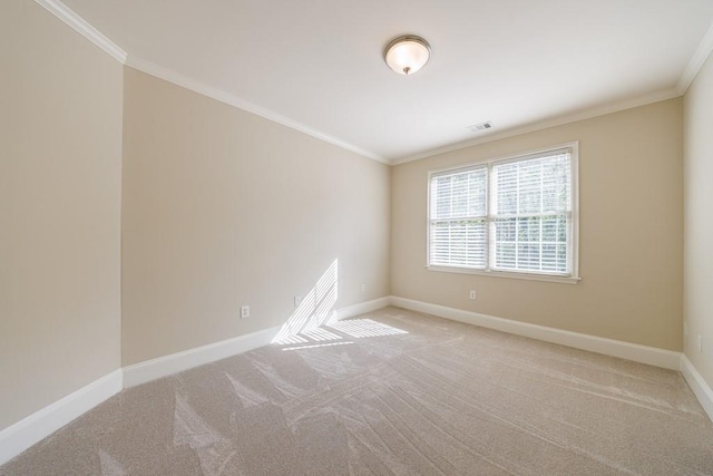 carpeted spare room featuring baseboards, crown molding, and visible vents