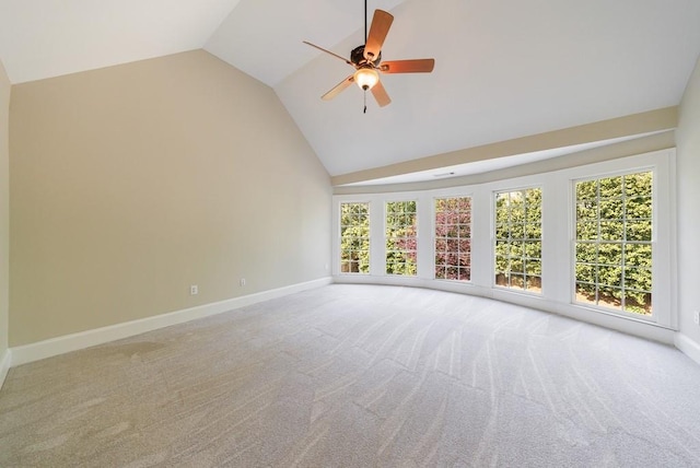 carpeted spare room featuring high vaulted ceiling, baseboards, and a ceiling fan