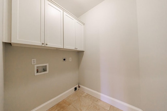clothes washing area with baseboards, washer hookup, hookup for an electric dryer, and cabinet space