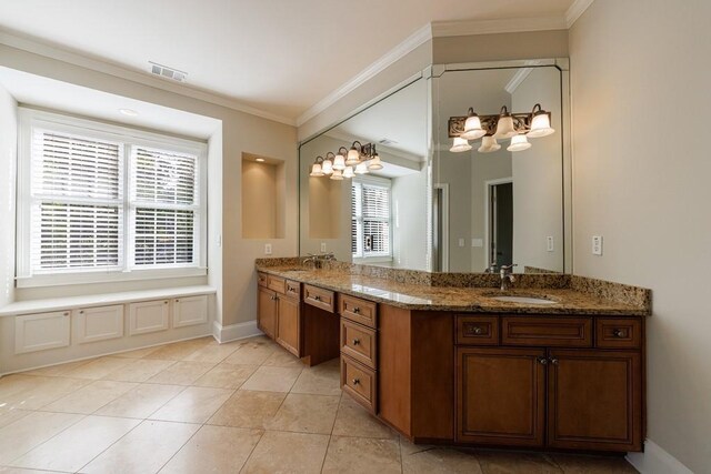 bathroom with crown molding, a chandelier, a sink, and double vanity