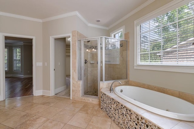 full bathroom with a wealth of natural light, a shower stall, and crown molding