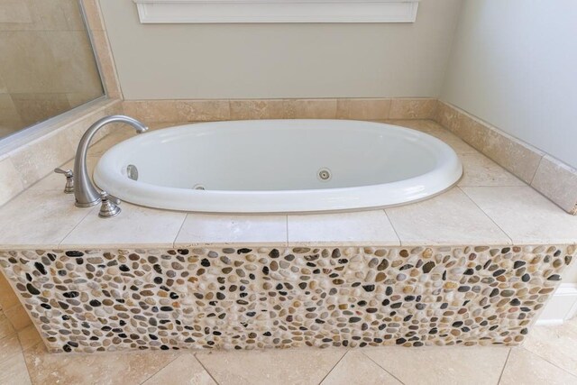 bathroom with tile patterned floors and a jetted tub