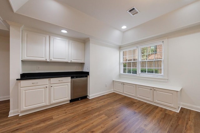 kitchen featuring white cabinets, dishwasher, visible vents, and wood finished floors