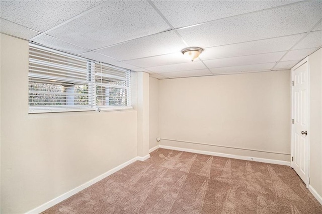 basement with carpet and a drop ceiling