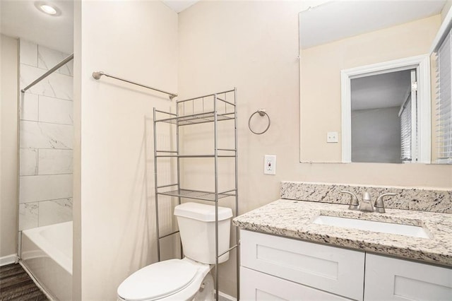 full bathroom with wood-type flooring, toilet, tiled shower / bath, and vanity