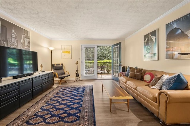 living area featuring a textured ceiling, ornamental molding, and wood finished floors