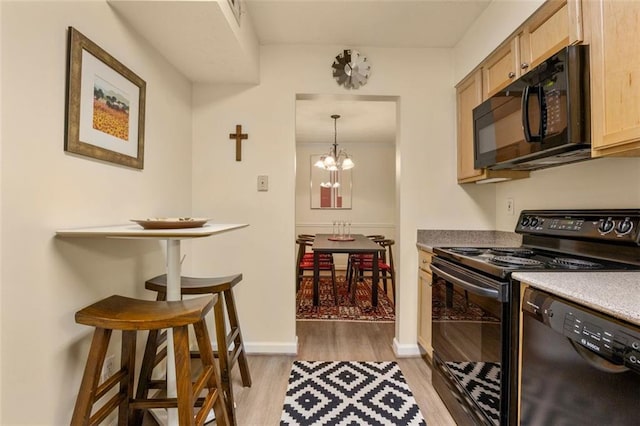 kitchen with an inviting chandelier, light brown cabinets, baseboards, light wood-style flooring, and black appliances