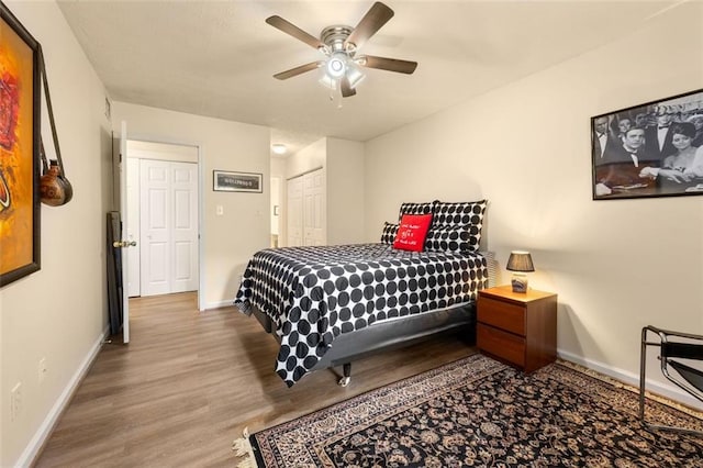 bedroom featuring baseboards, ceiling fan, and wood finished floors