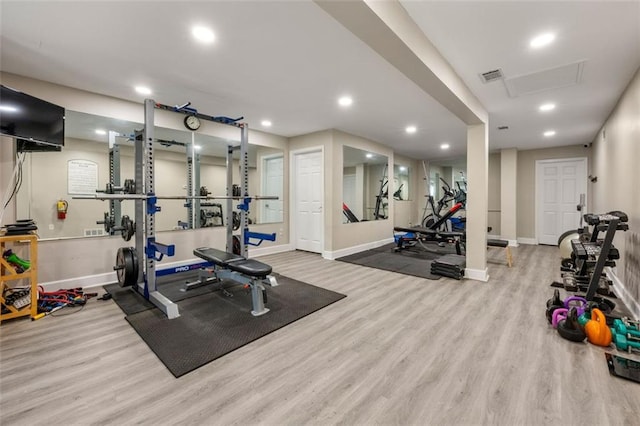 workout area featuring recessed lighting, baseboards, visible vents, and wood finished floors