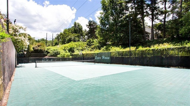 view of tennis court featuring fence