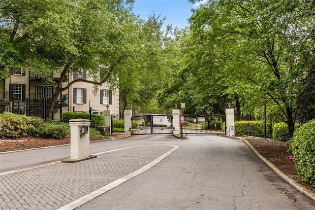 view of property's community with fence and a gate