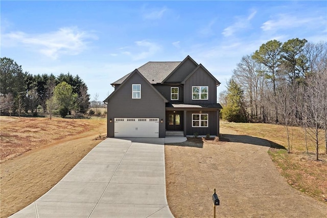 view of front facade featuring board and batten siding, driveway, and an attached garage