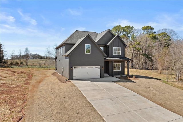 view of front of home with board and batten siding, driveway, and an attached garage