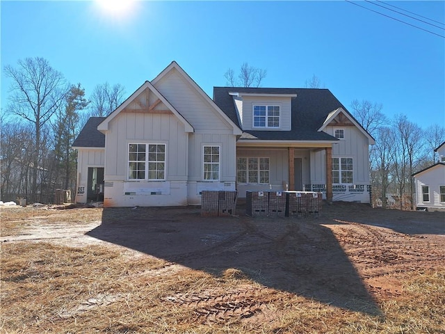 rear view of house featuring covered porch and board and batten siding