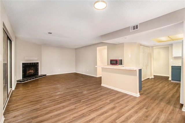 unfurnished living room featuring hardwood / wood-style floors and a fireplace