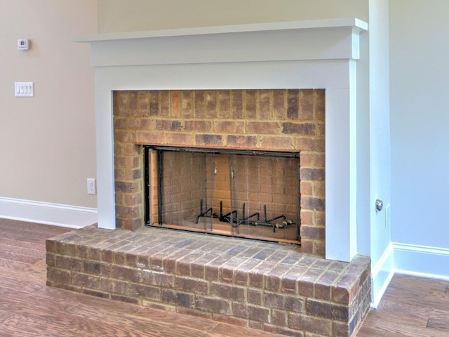 3730 Reserve Overlook Way, Cumming, GA 30041 - detailed view of baseboards, a brick fireplace, and wood finished floors