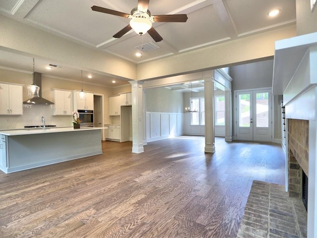 3730 Reserve Overlook Way, Cumming, GA 30041 - unfurnished living room featuring ornate columns, wood finished floors, ceiling fan, recessed lighting, and crown molding