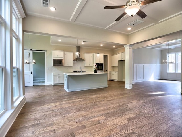 3730 Reserve Overlook Way, Cumming, GA 30041 - kitchen featuring wall chimney range hood, a chandelier, stainless steel appliances, dark wood-style flooring, and a decorative wall